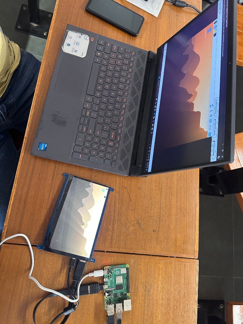 Pi on the bench with its display, and the same desktop on the laptop.